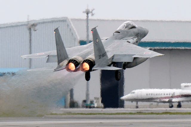 <p>A Japanese Air Self Defence Force F-15 fighter scrambles at the Air Self Defense Force Naha base in Naha, Okinawa</p>