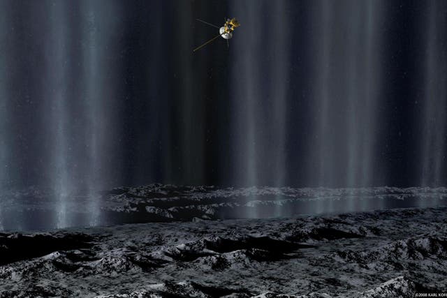 In this artist's concept, the Cassini spacecraft makes a close pass by Saturn's moon Enceladus to study plumes from geysers that erupt from giant fissures in the moon's southern polar region