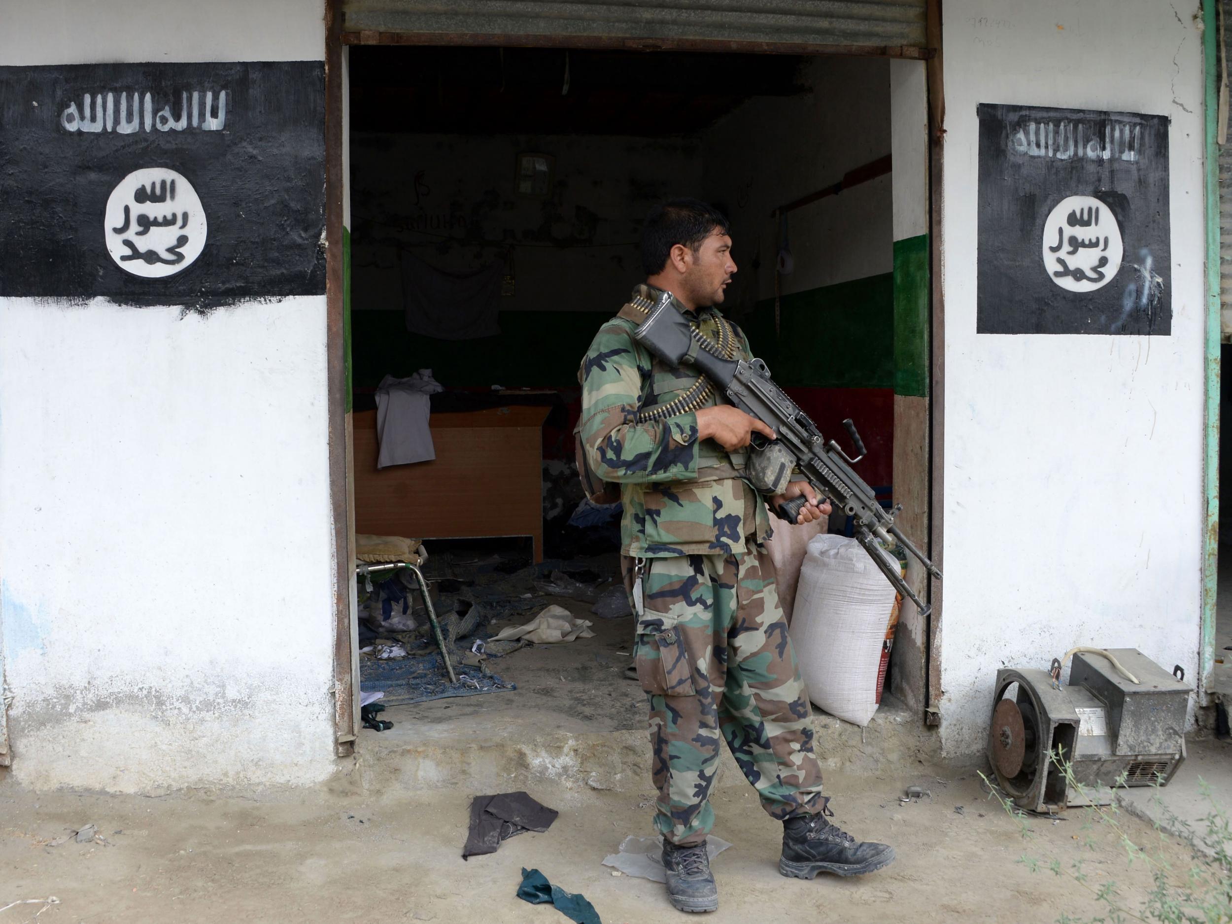An Afghan government soldier guards a building previously held by Isis in Nangarhar province