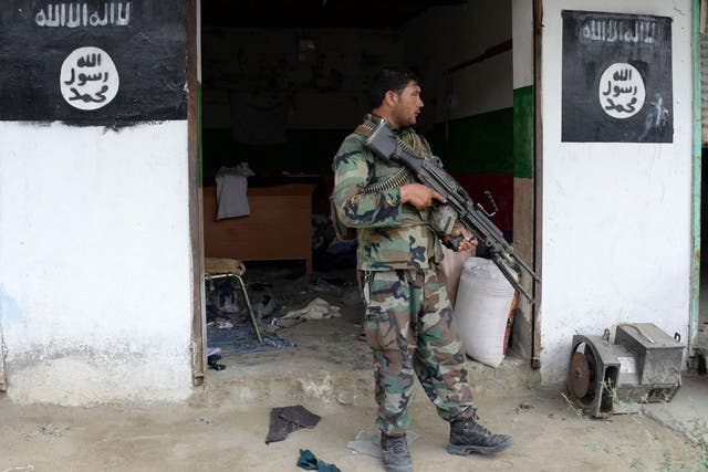 An Afghan government soldier guards a building previously held by Isis in Nangarhar province