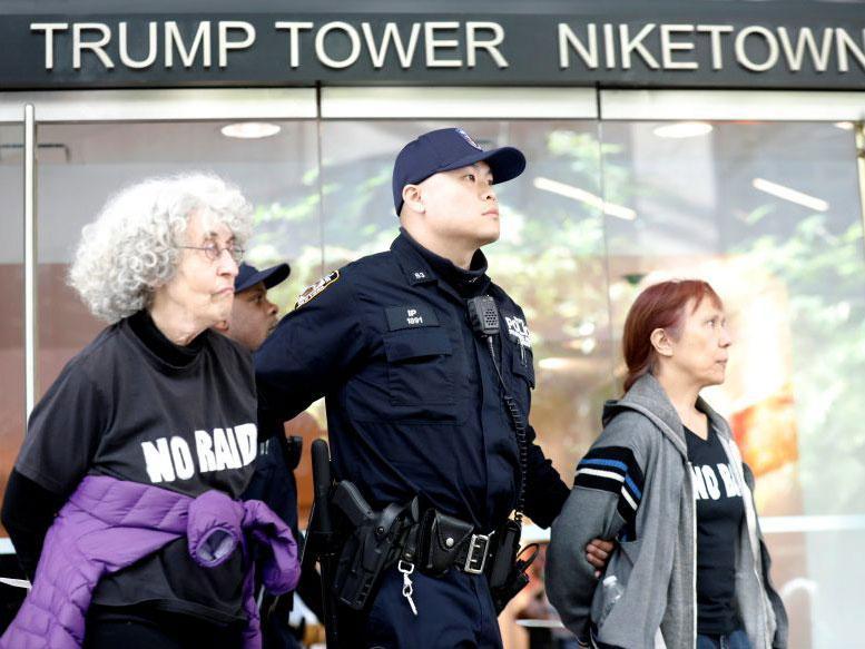 Protesters are led way from Trump Tower by police