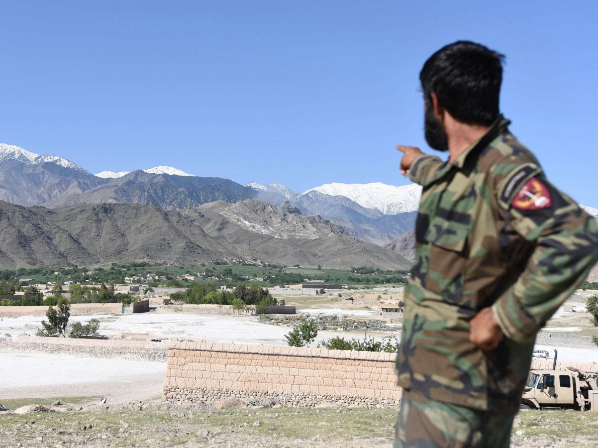 A member of Afghan security points to the mountainous area where the US on dropped a GBU-43 Massive Ordnance Air Blast (MOAB) bomb targeting Isis caves in Asad Khel area of Achin district of Nangarhar province, Afghanistan