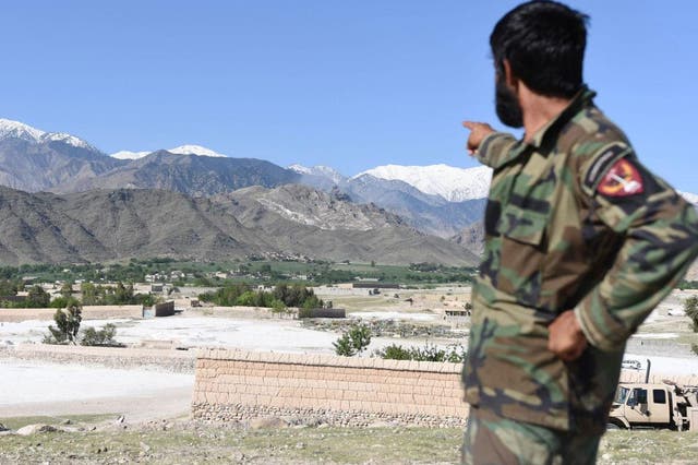 A member of Afghan security points to the mountainous area where the US on dropped a GBU-43 Massive Ordnance Air Blast (MOAB) bomb targeting Isis caves in Asad Khel area of Achin district of Nangarhar province, Afghanistan
