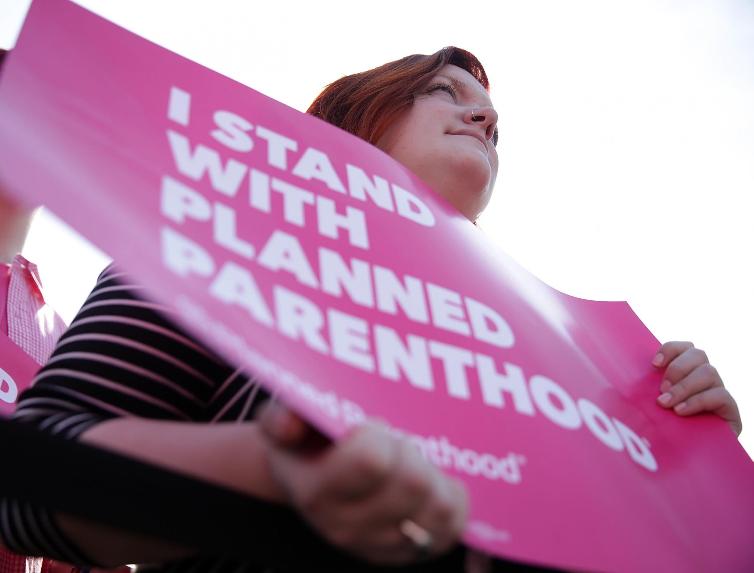 Activists participate in a rally to support Planned Parenthood
