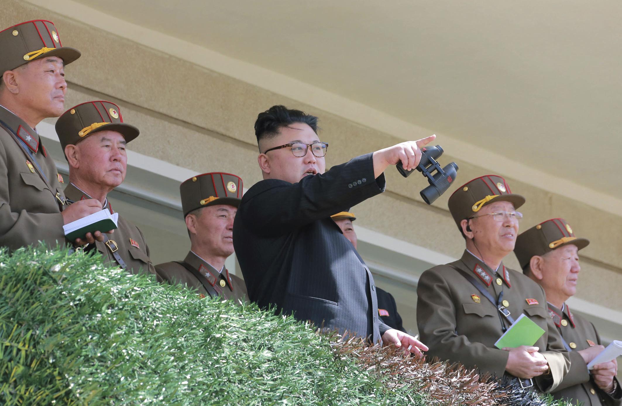 North Korean leader Kim Jong Un watches a military drill at an undisclosed location