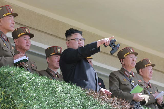 North Korean leader Kim Jong Un watches a military drill at an undisclosed location