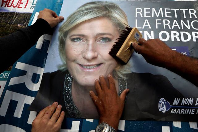A billboard poster for French National Front leader Marine Le Pen in Antibes. After Sunday's vote, she will face a run-off with Emmanuel Macron on 7 May