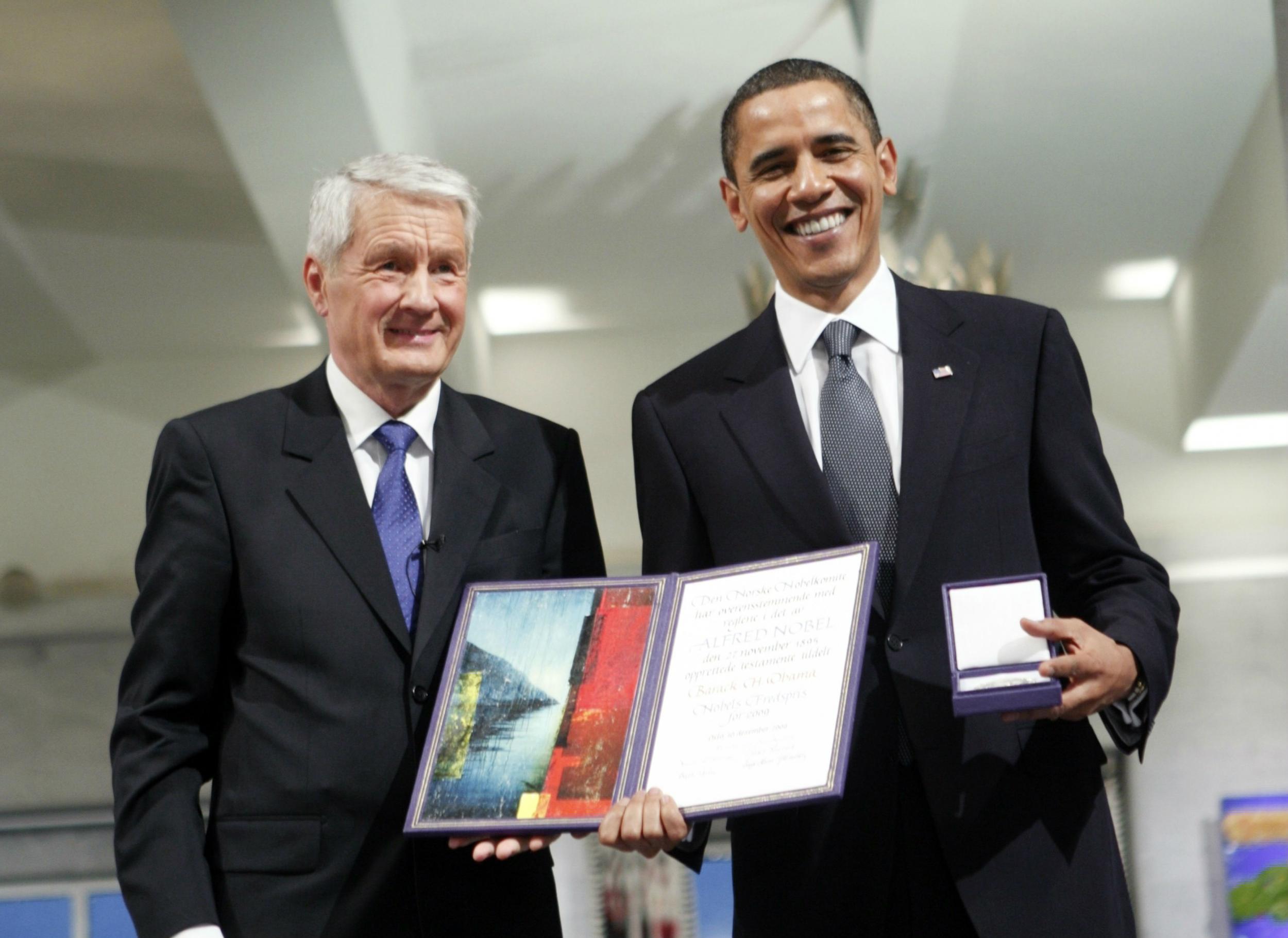 Barack Obama accepting his Nobel Peace Prize from Thorbjorn Jagland, chair of the Norwegian Nobel Committee, in December 2009