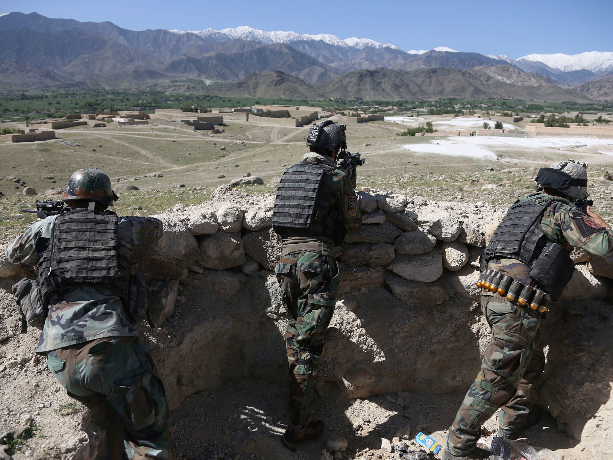 Afghan commandos are positioned in Pandola village, near the site of the US bomb drop