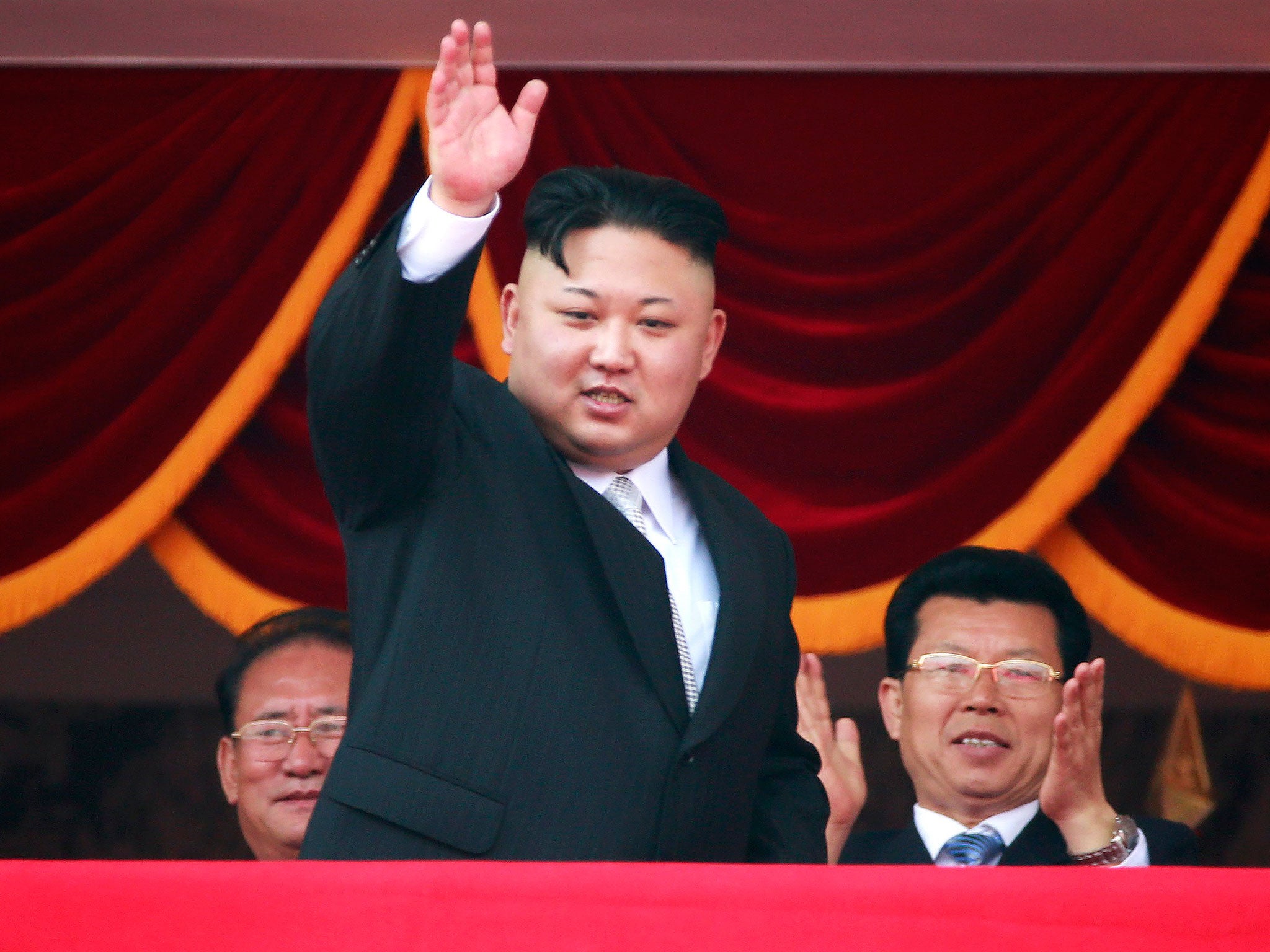 North Korean leader Kim Jong-un waves from a balcony during a parade for the 'Day of the Sun' festival in Pyongyang on Saturday