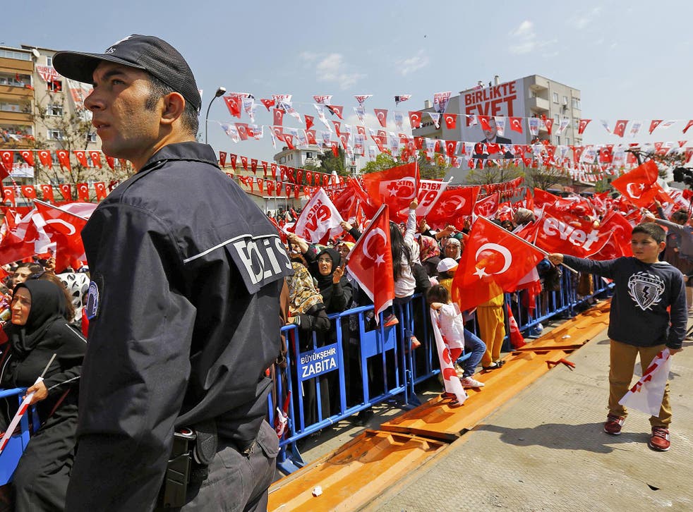 Erdogan supporters wave national flags and Yes campaign flags at a rally ahead of the referendum