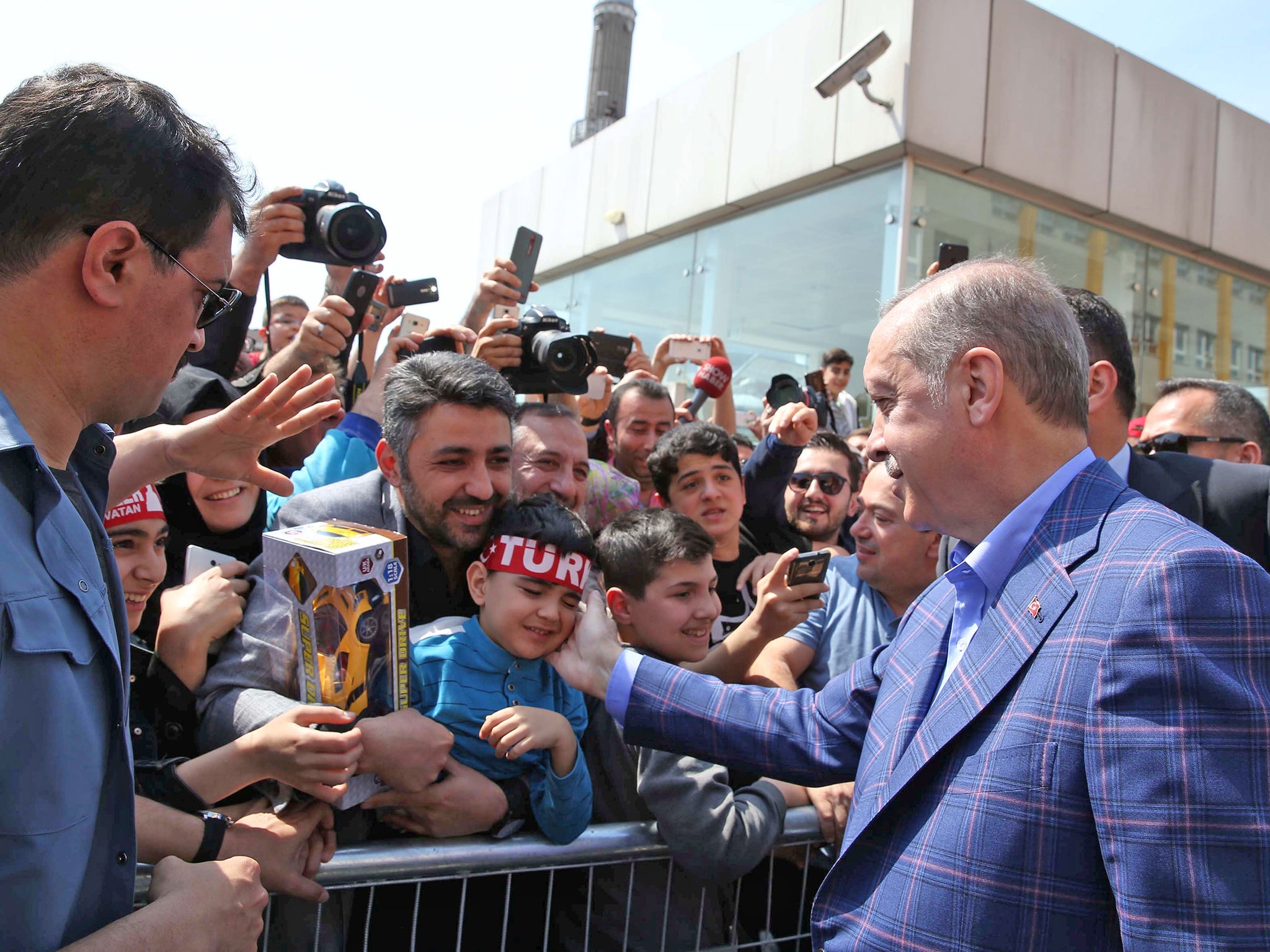 President Erdogan greets supporters outside a polling station. A 'yes' vote would make him immensely powerful