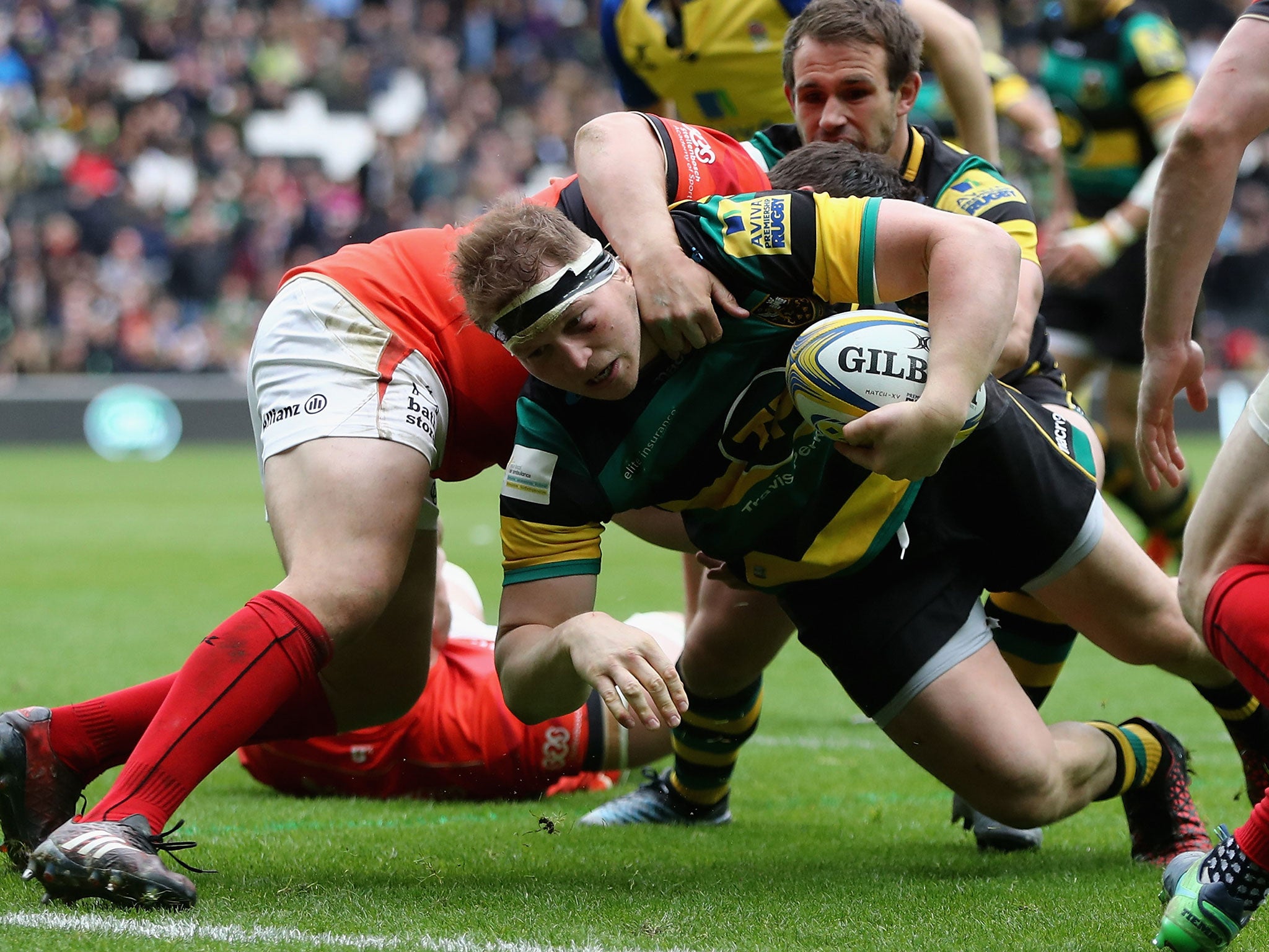 Dylan Hartley dives over for a try despite being held by Jamie George