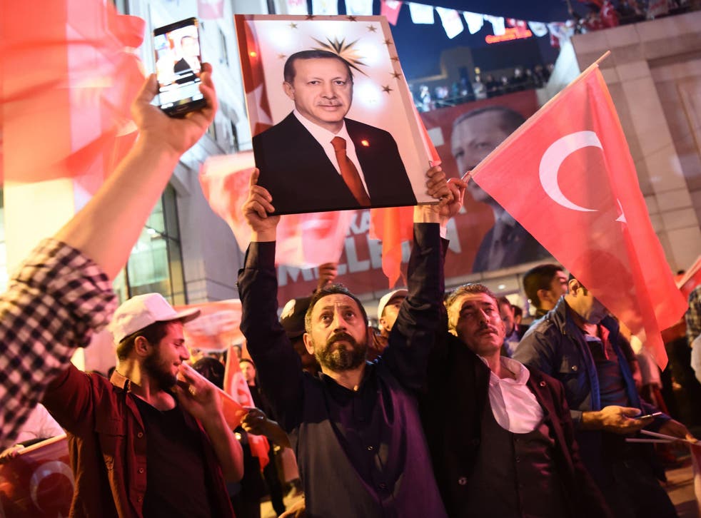 A supporter of the 'Yes' campaign brandishes a picture of Turkish president Recep Tayyip Erdogan 