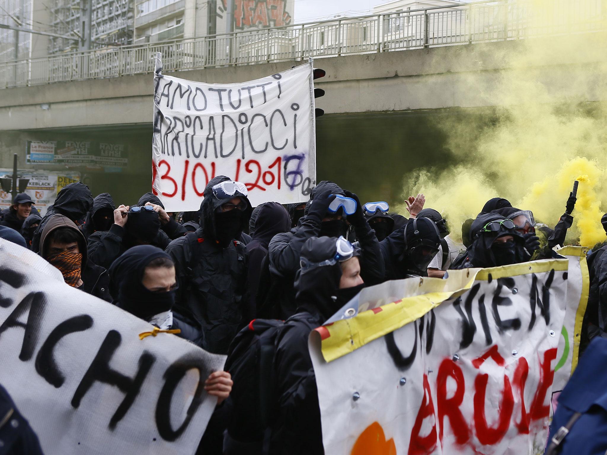 Protesters against far-right National Front leader and presidential candidate Marine Le Pen hold a banner reading 'fascist' during a protest march from suburban Aubervilliers to Paris