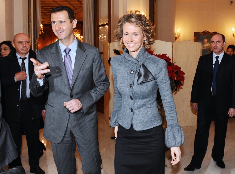 Syrian President Bashar al-Assad (foregorund L) with his wife Asma