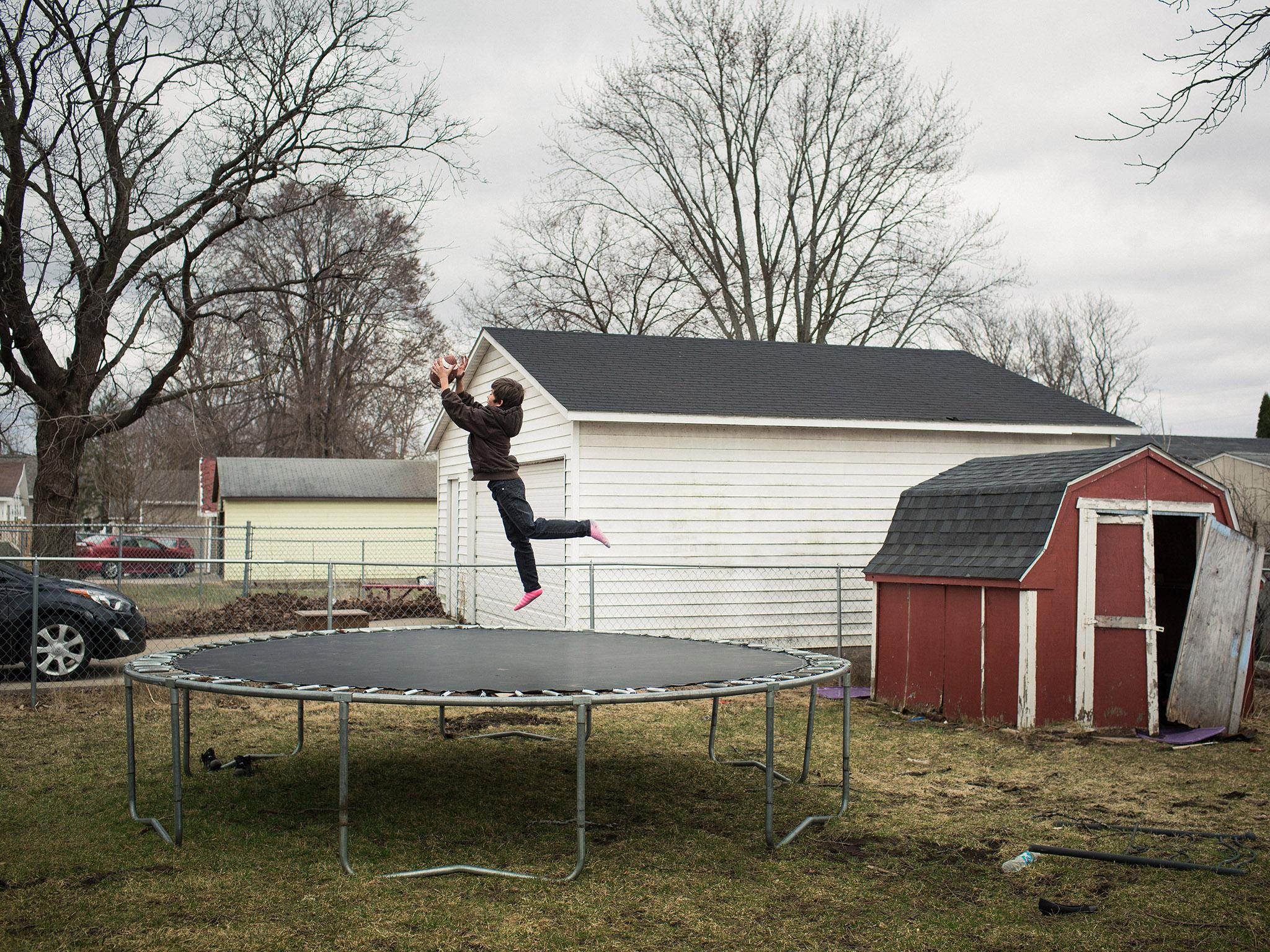 Karlos Denson, nine, plays outside his home in the Fourth Ward, considered one of Janesville's rougher neighbourhoods