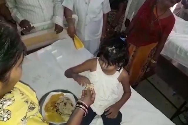 Picture: young girl, found in Uttar Pradesh being fed/