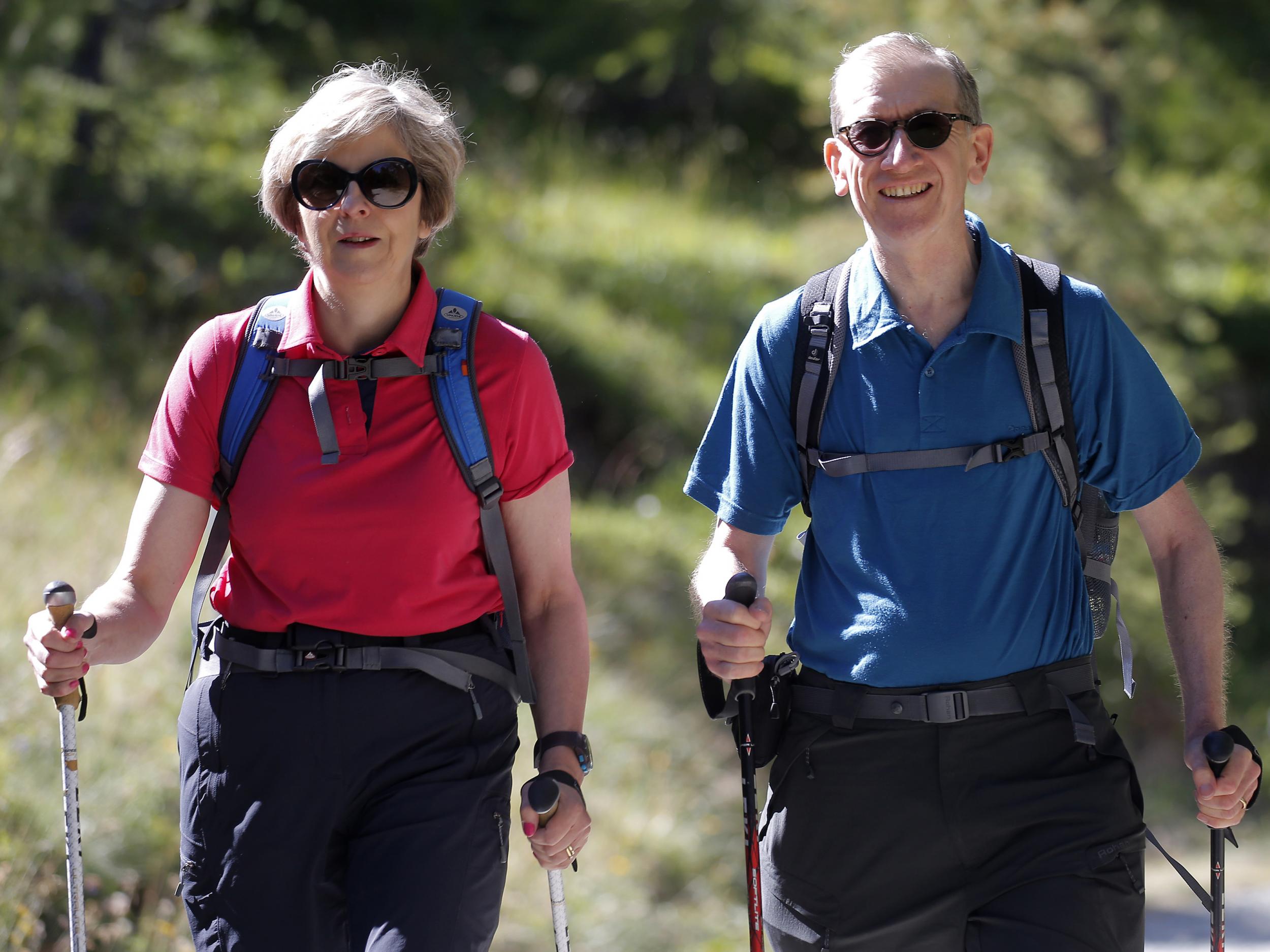 May told reporters it was watching the ice melt in Switzerland with husband Philip (right) that 'brought home' the reality of global warming