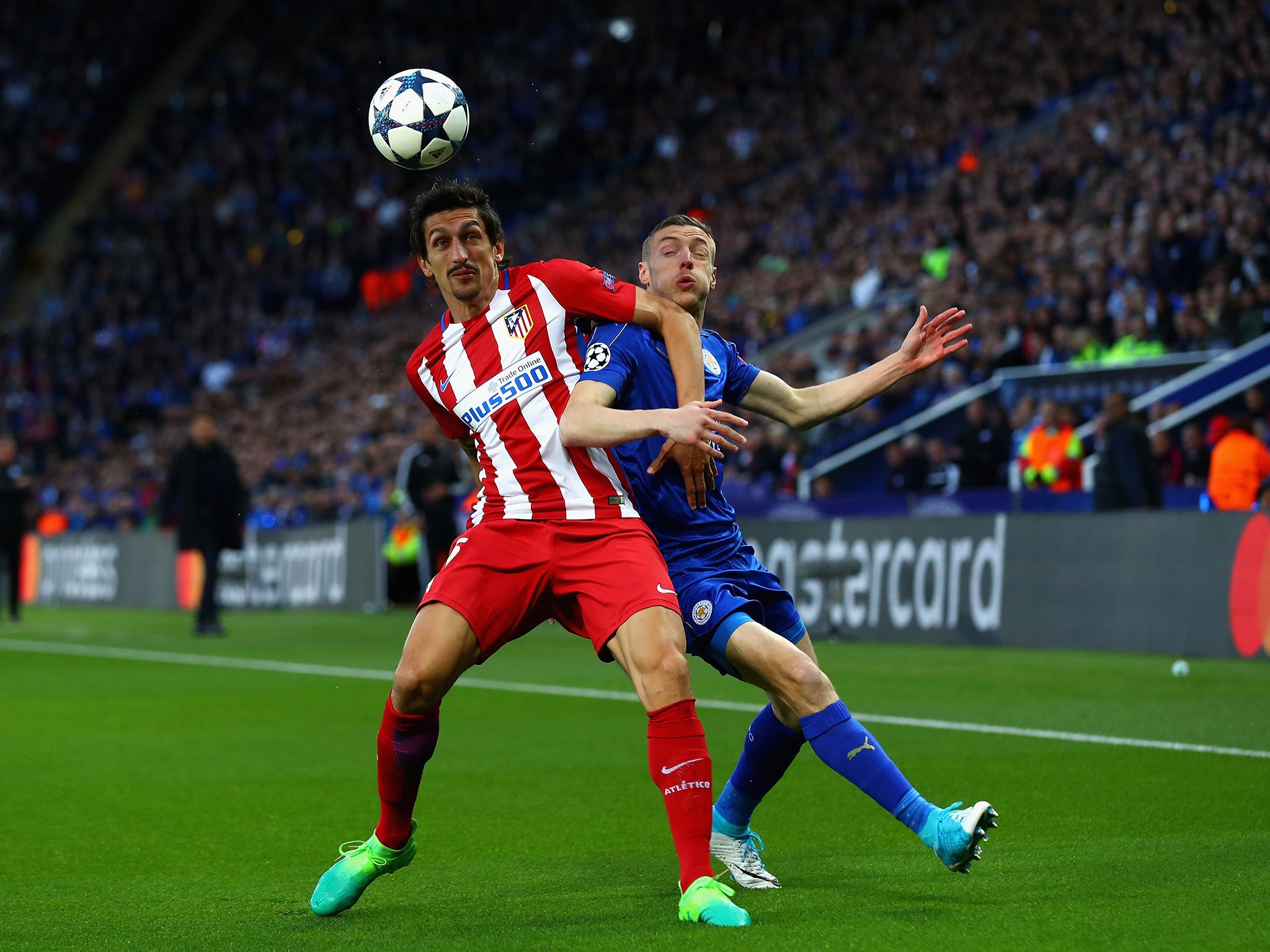 Stefan Savic and Jamie Vardy battle for the ball at the King Power
