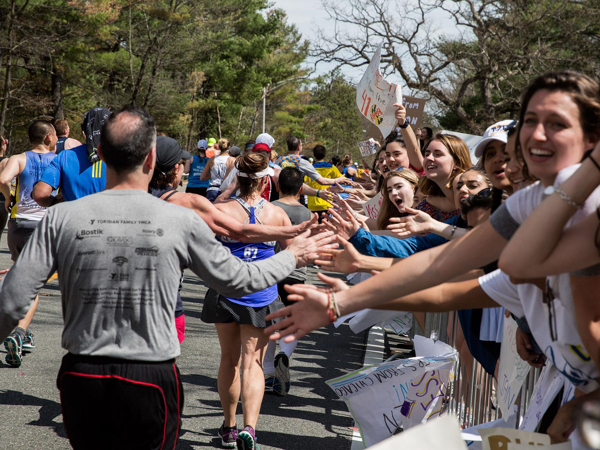 Crowds cheer on Boston Marathon runners in the iconic 'scream tunnel' near Wellesley College on April 17, 2017, in Wellesley Massachusetts