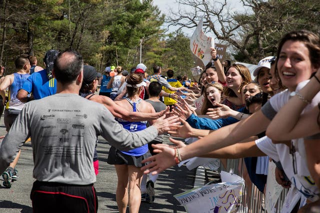 Crowds cheer on Boston Marathon runners in the iconic 'scream tunnel' near Wellesley College on April 17, 2017, in Wellesley Massachusetts