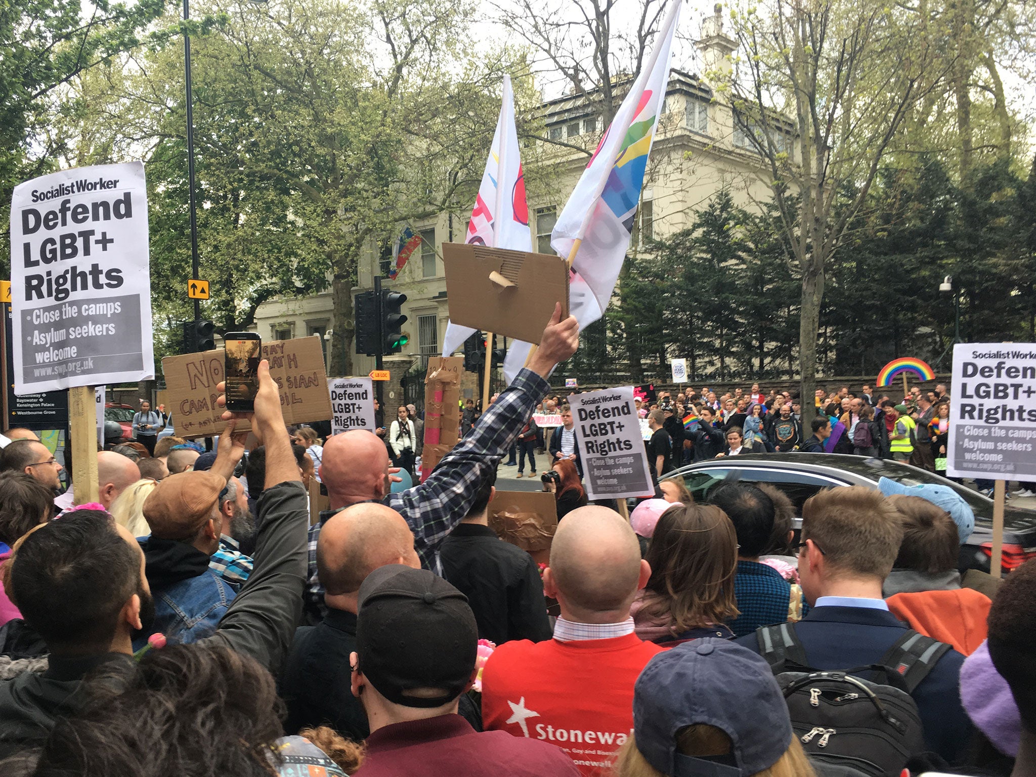 People hold a protest outside the Russian Embassy in London, following reports of the torture and murder of gay men in Chechnya on 12 April