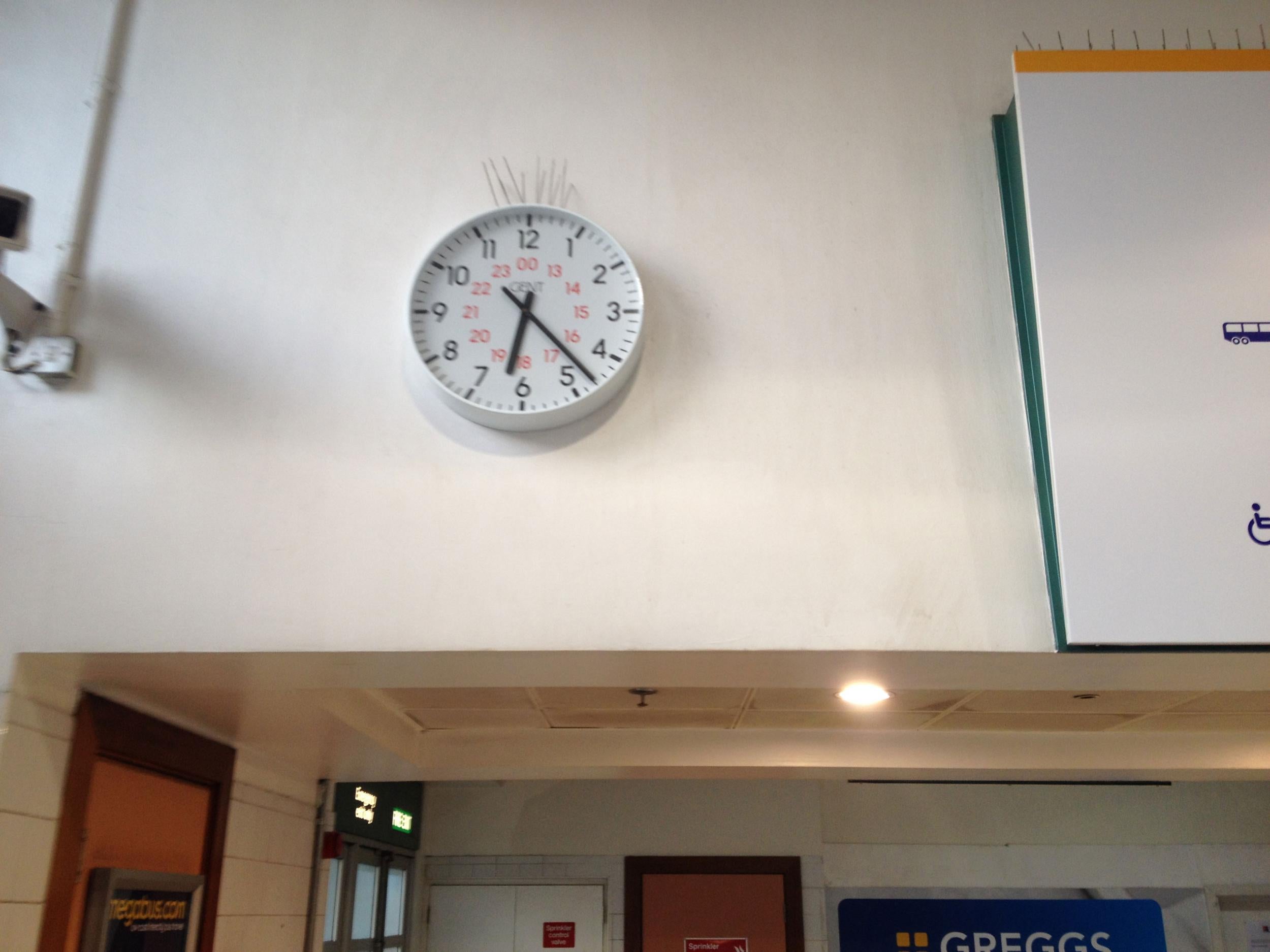 A clock at Victoria coach station tells the time