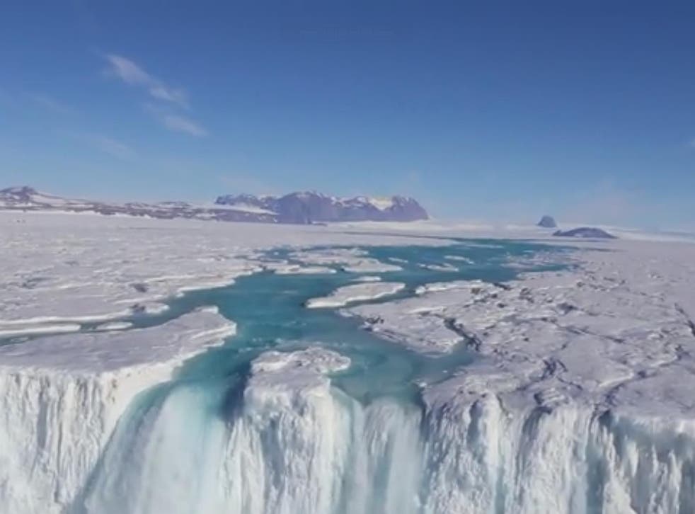 A river of meltwater flows over 120-metre wide waterfall in Antarctica