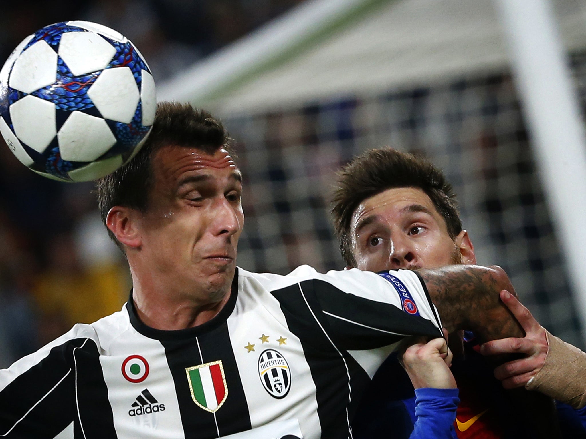 Lionel Messi battles with Mario Mandzukic for the ball