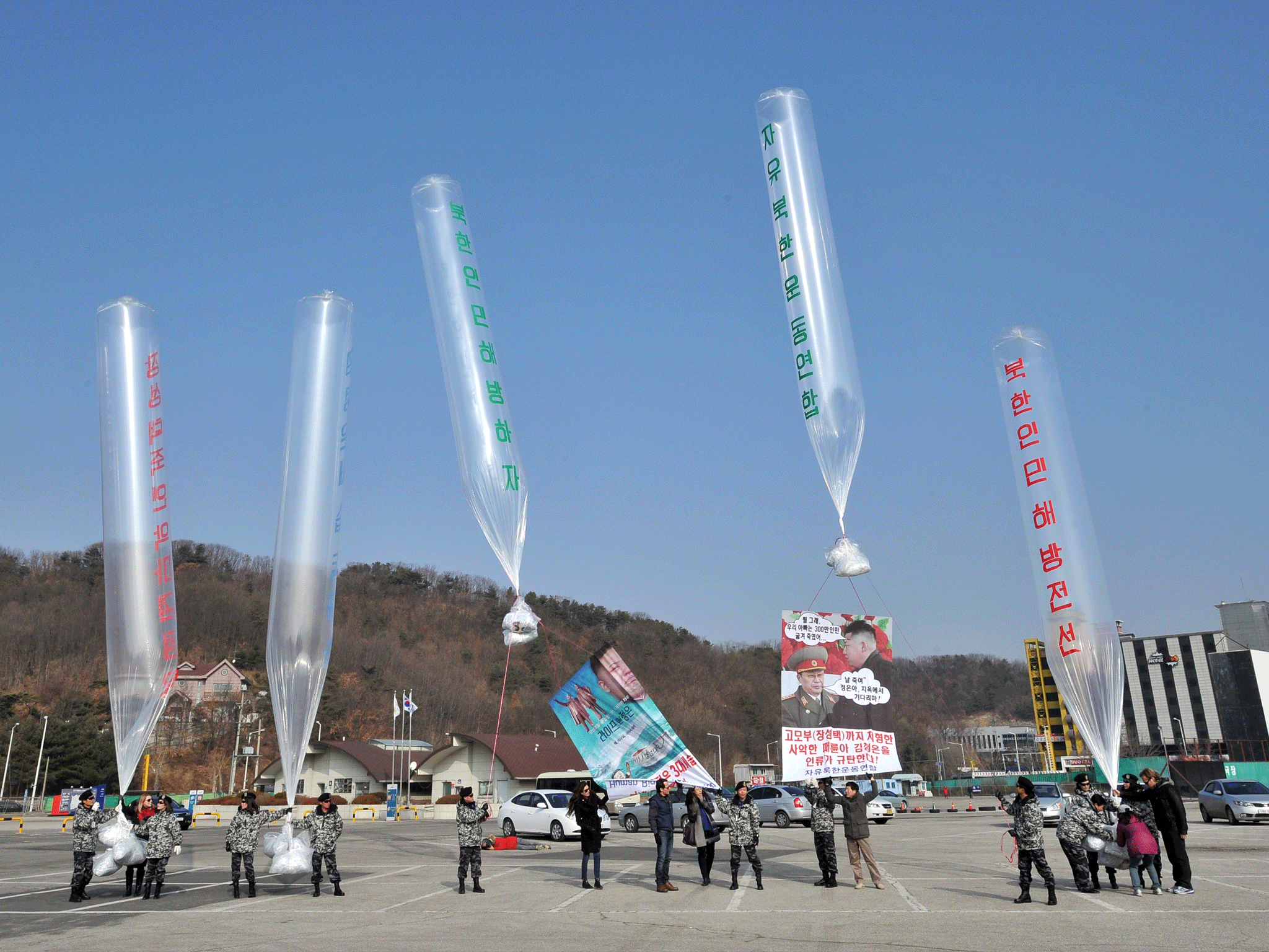 Former North Korean defectors and US human rights activists release balloons carrying anti-North Korea leaflets at a park in the border town of Paju, north of Seoul