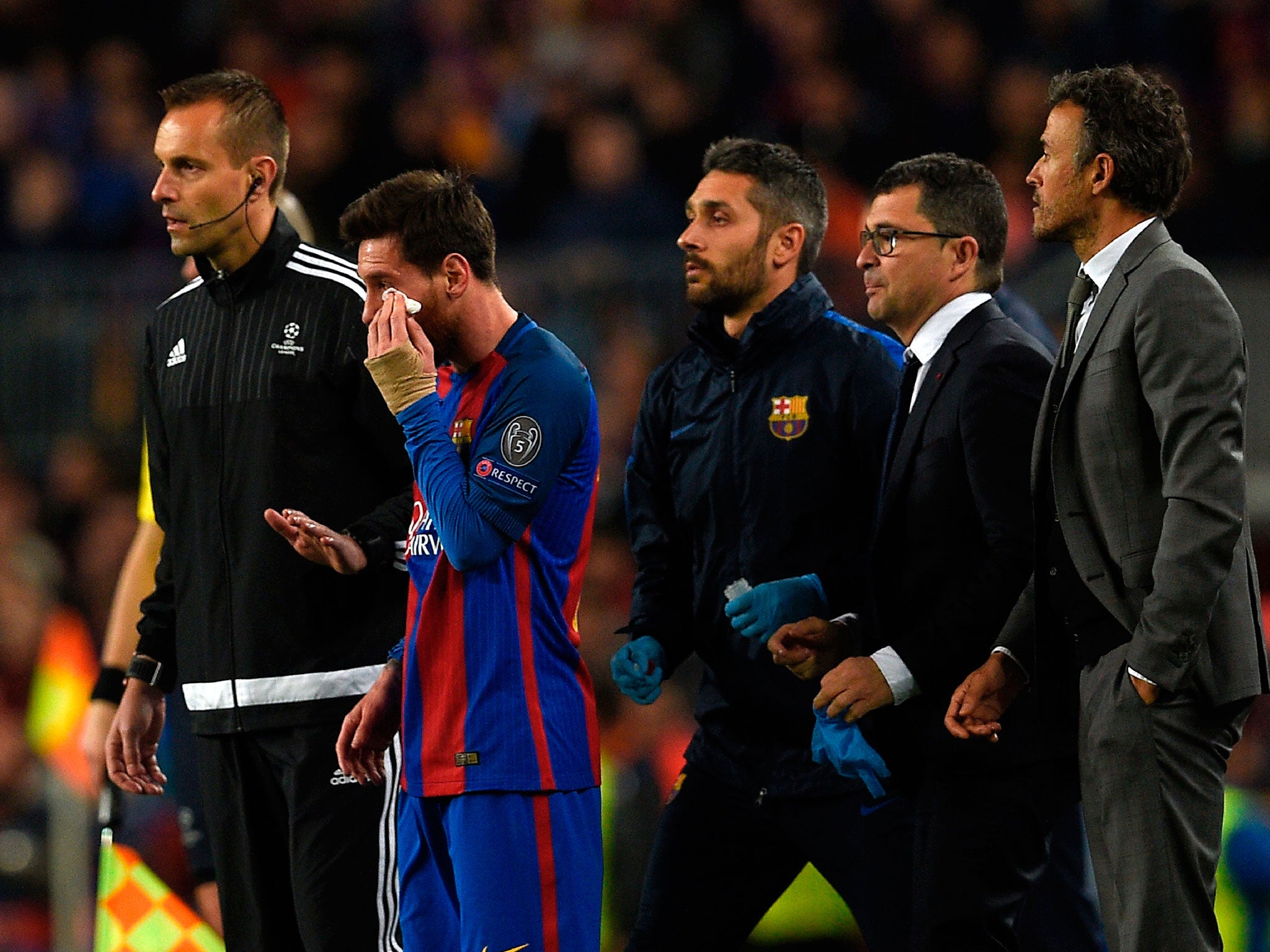 Messi receives treatment after his clash with Pjanic