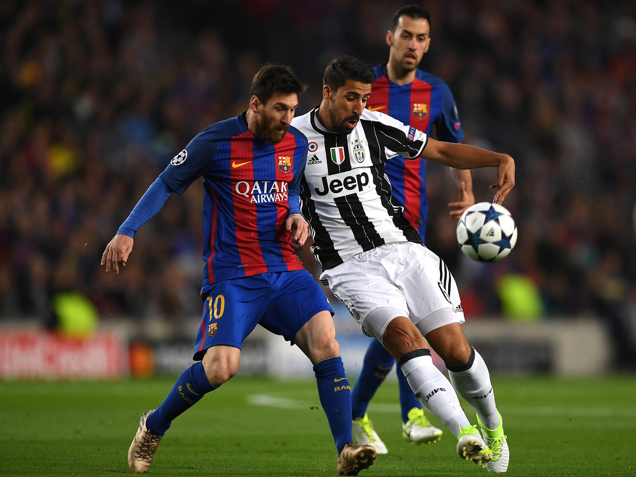 Lionel Messi battles with Sami Khedira for the ball