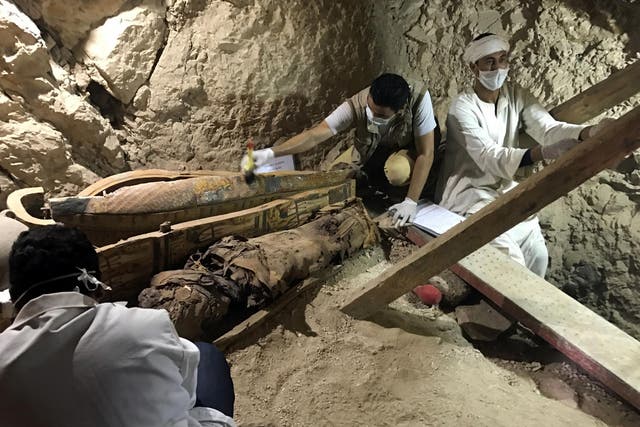 Egyptian antiquities workers are seen in the tomb of Userhat, a judge from the New Kingdom at the Dra Abu-el Naga necropolis near the Nile city of Luxor