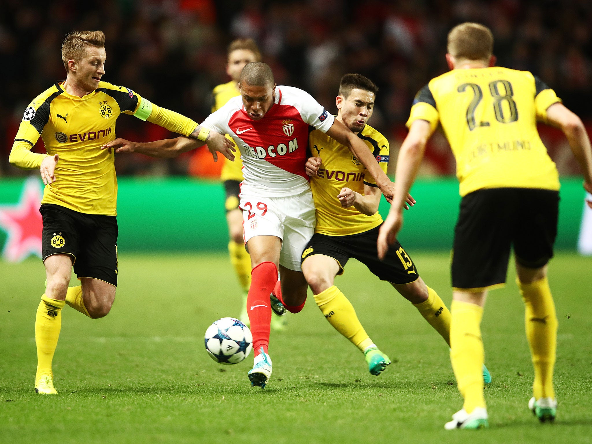 Mbappe tries to make his way through a group of Dortmund players