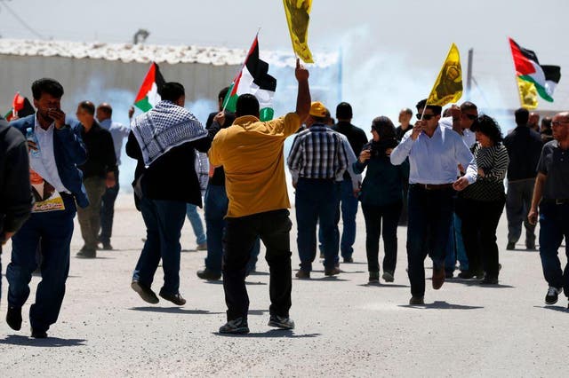 Palestinians protest in solidarity with prisoners on hunger strike in Israeli jails, in front of the Israeli-run Ofer prison in the West Bank village of Betunia on April 20, 2017