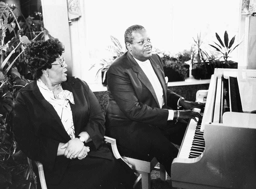 Oscar Peterson and Ella Fitzgerald performing at a piano together, at a press reception at Grosvenor House Hotel, London, in 1980