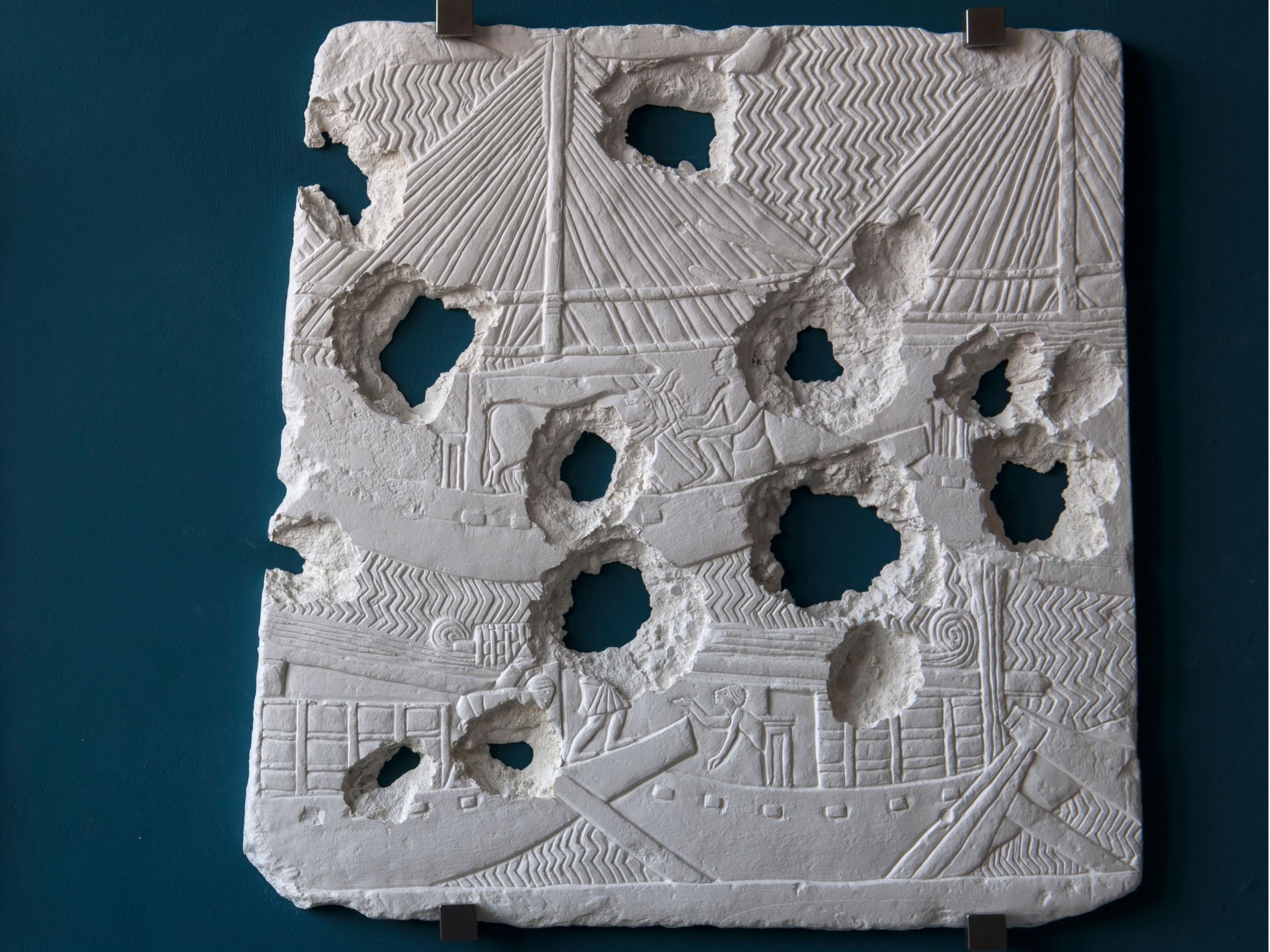 Bullet holes riddle a cast of Assyrian boats (Secunda)