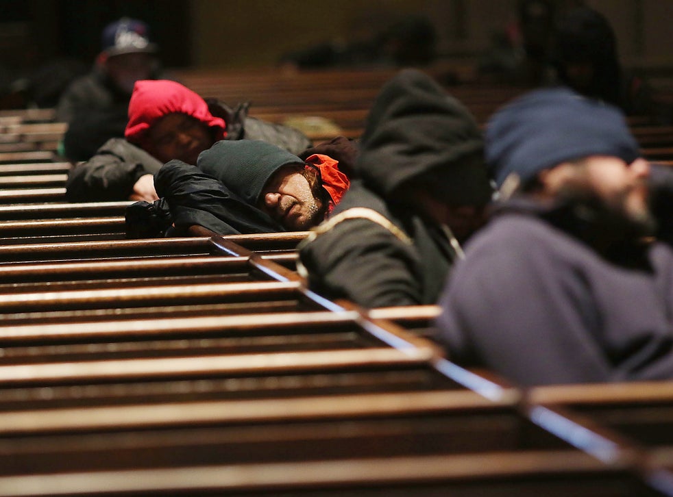 Homeless men try to stay warm in a Manhattan church on an unseasonably cold day in New York City