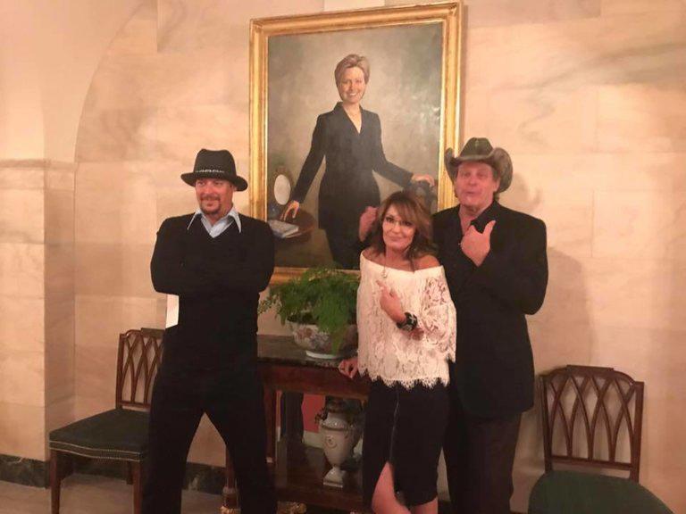 Sarah Palin posted a snap of herself, Kid Rock (left) and Ted Nugent (right) posing in front of Hillary Clinton's portrait on her Facebook page
