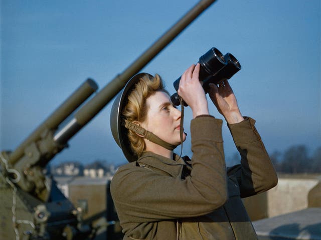 An Auxiliary Territorial Service (ATS) 'spotter' at a 3.7-inch anti-aircraft gun site, December 1942. The photo - taken on colour film - is one of a rare collection which has been released by the Imperial War Museum