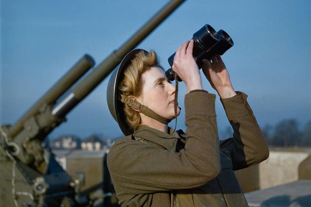 An Auxiliary Territorial Service (ATS) 'spotter' at a 3.7-inch anti-aircraft gun site, December 1942. The photo - taken on colour film - is one of a rare collection which has been released by the Imperial War Museum