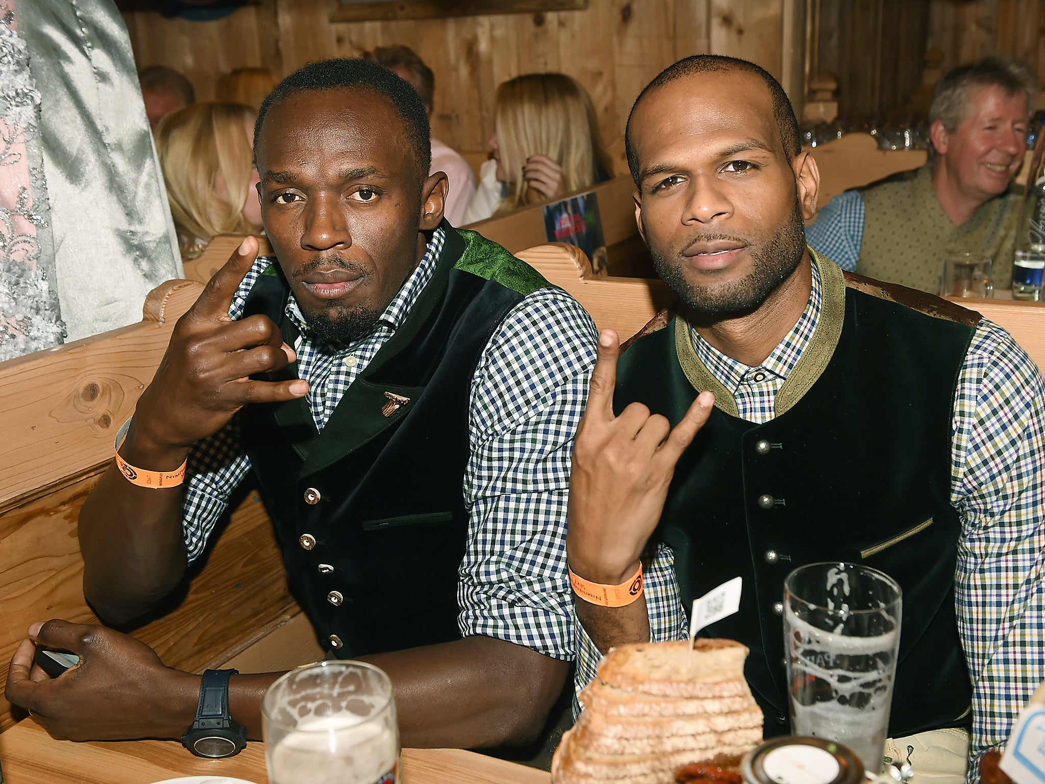 Jamaican sprinter Usain Bolt and Jamaican-born British high jumper Germaine Mason during a visit to one of the beer tents of the 'Oktoberfest' in Munich, Germany