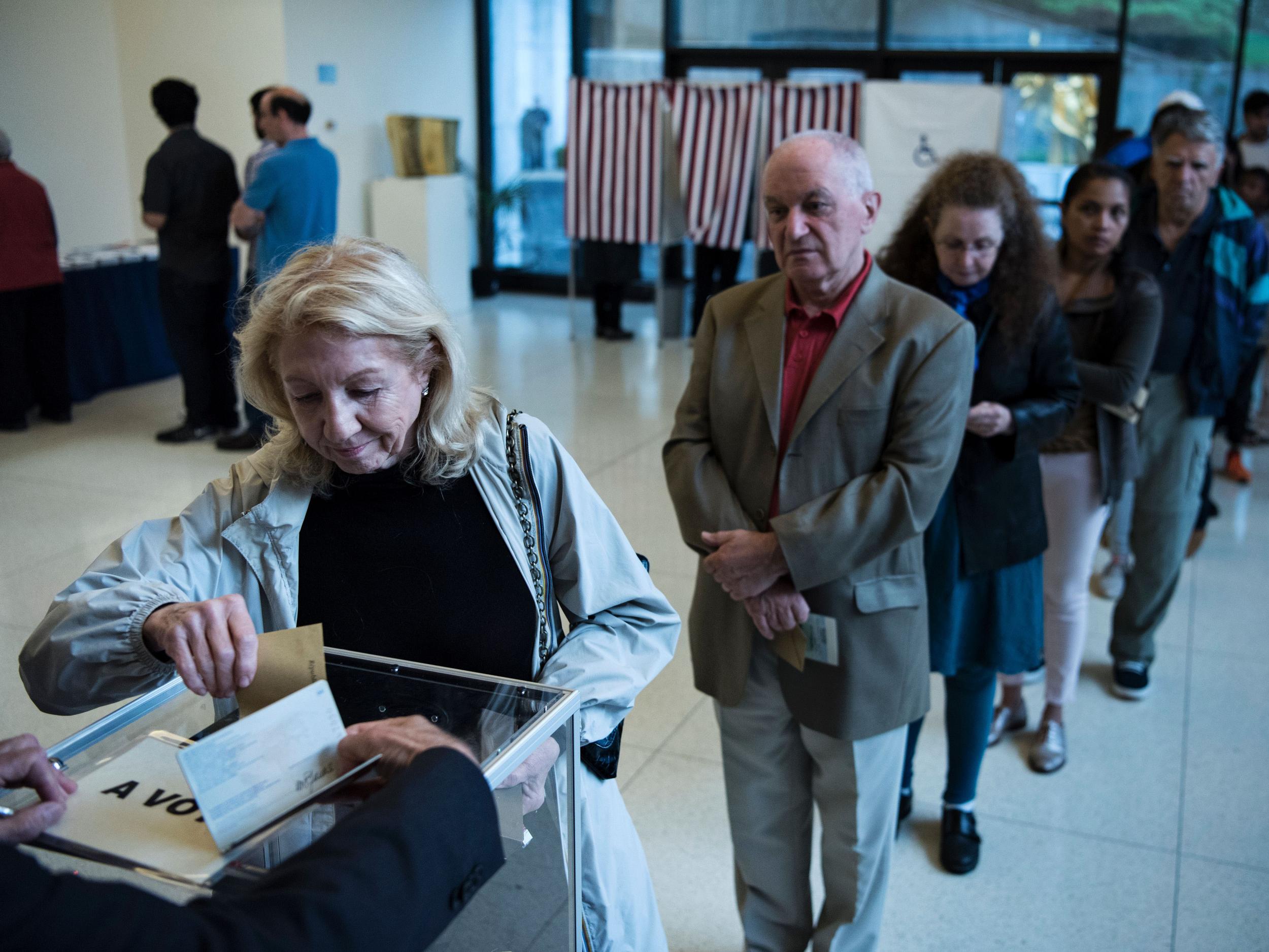 A French citizen casts her ballot at the French embassy in Washington DC