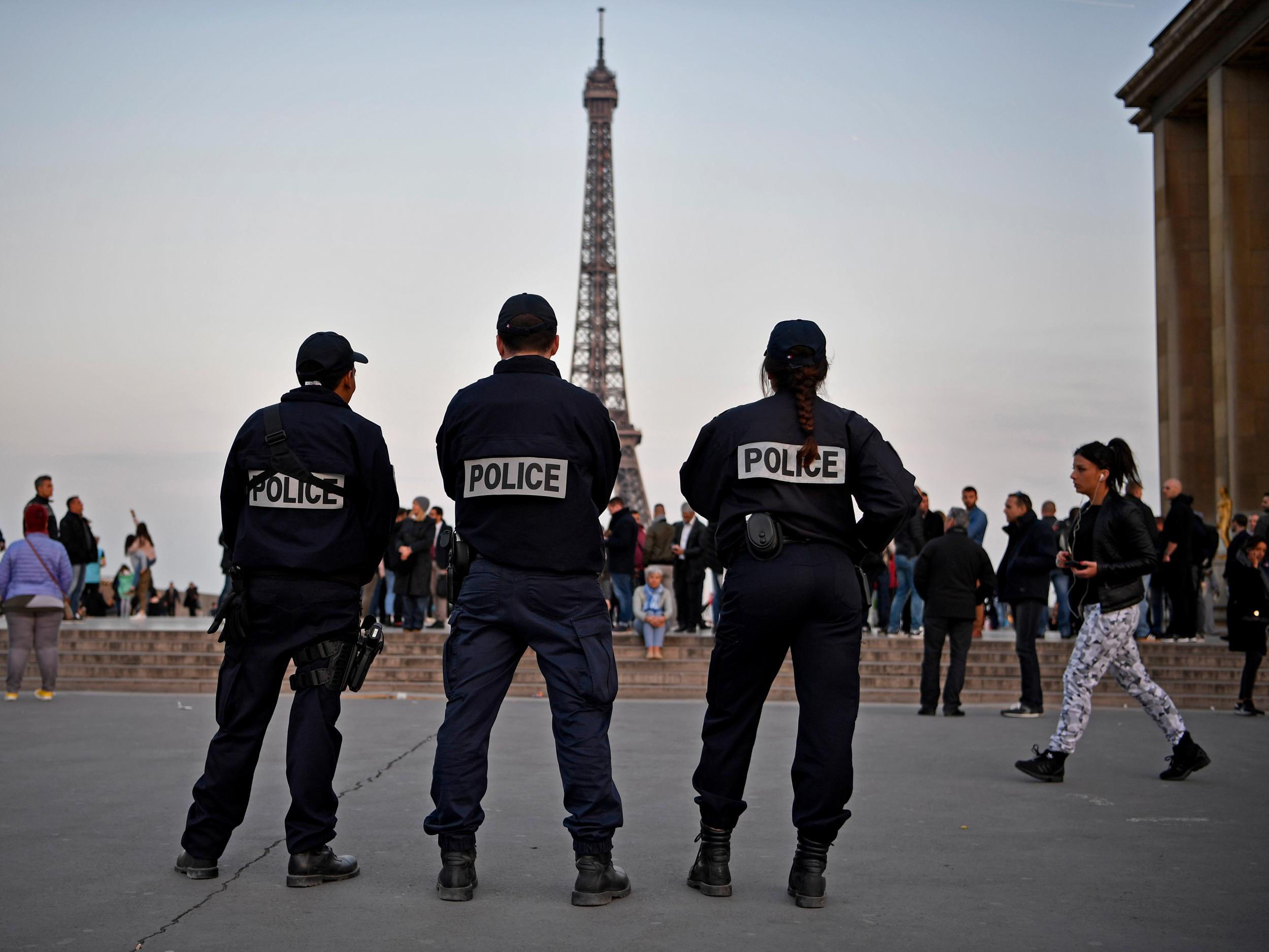 Police in front of the Eiffel Tower in Paris the day after a gunman opened fire on officers on the Champs-Elysees