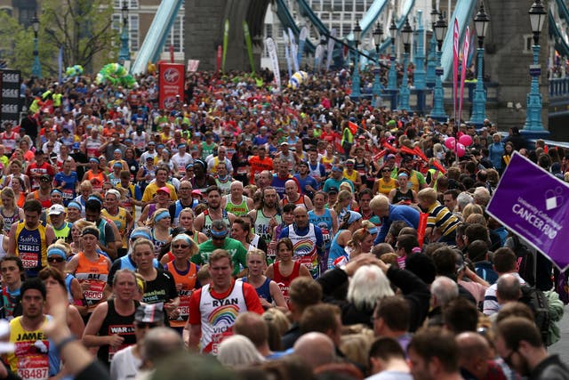 Runners make their way off Tower Bridge during the Virgin Money London Marathon, London