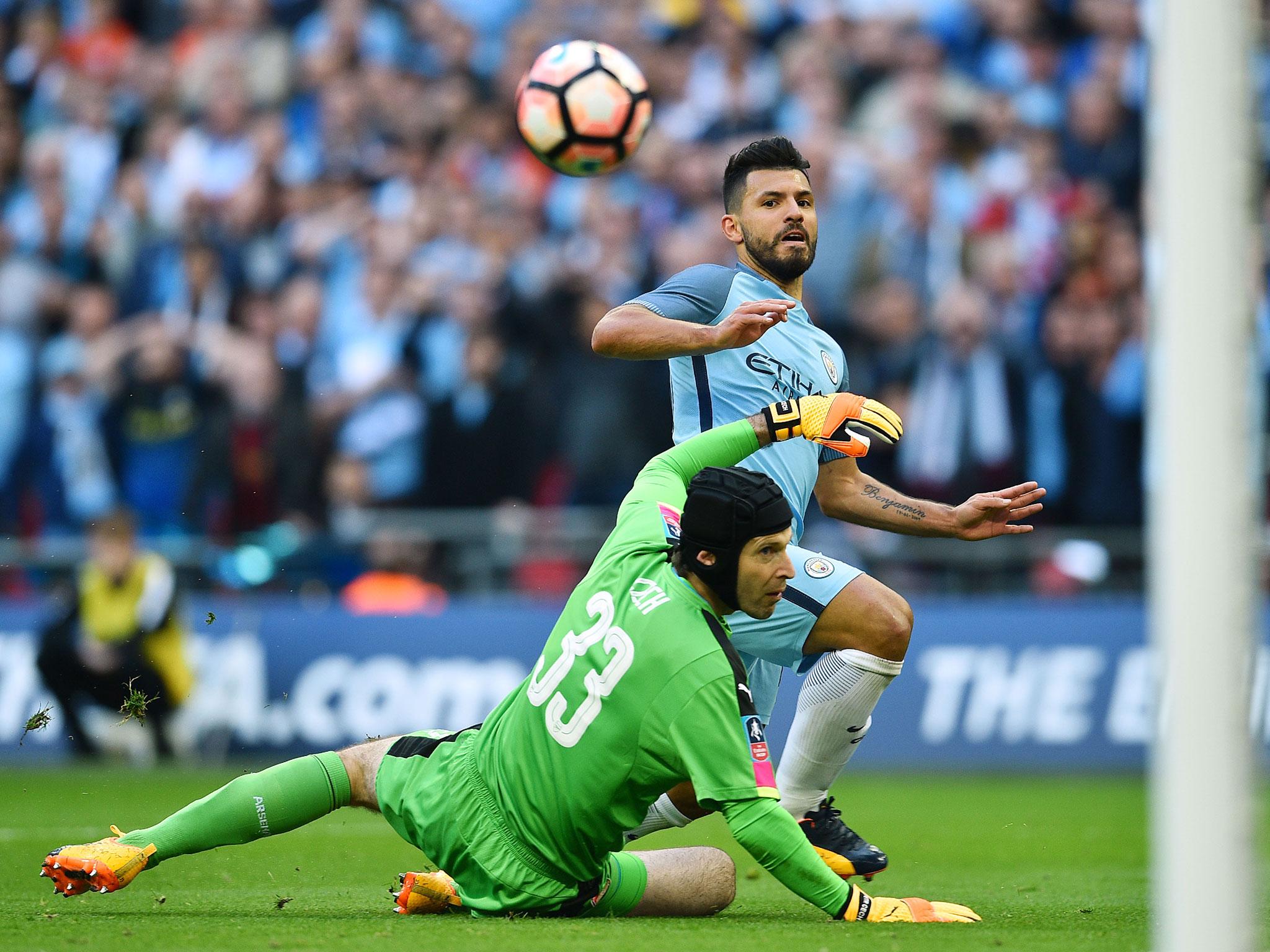 Sergio Aguero chips the ball over Petr Cech to score for Manchester City