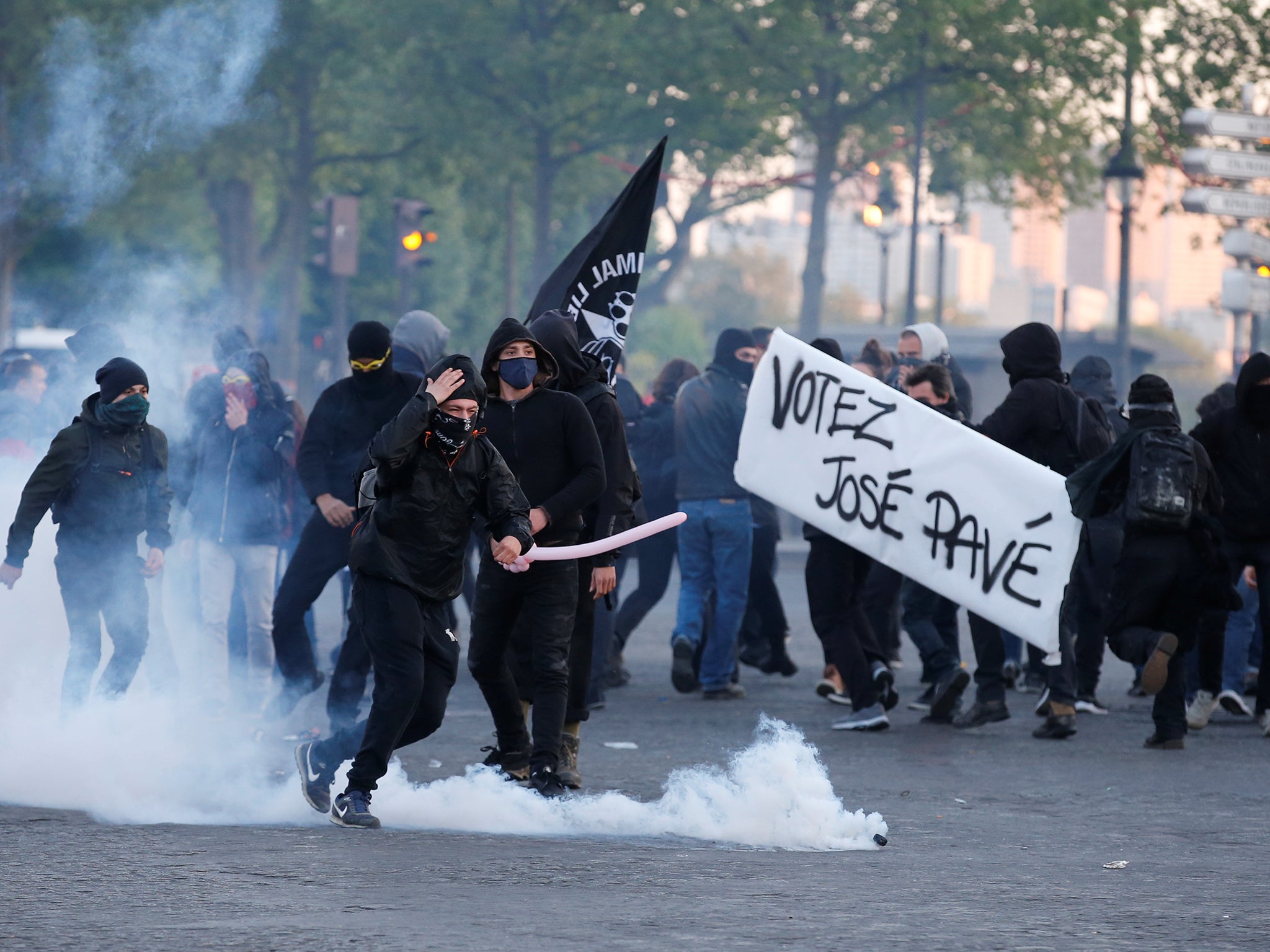 Tear gas floats in the air as demonstrators clash with French riot police after partial results in the first round of 2017 French presidential election, in Paris.