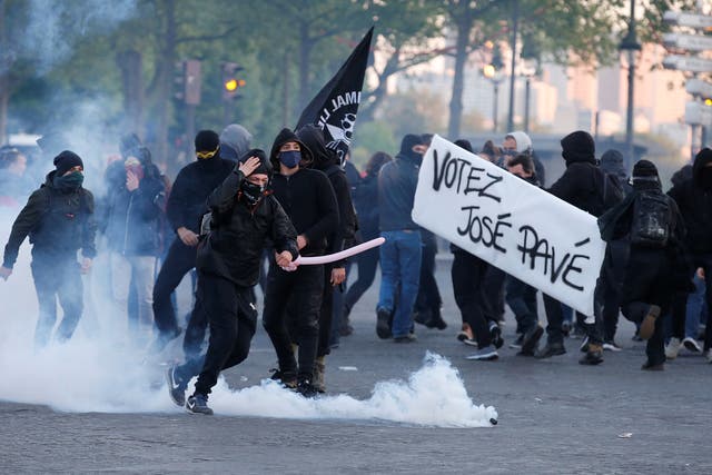 Tear gas floats in the air as demonstrators clash with French riot police after partial results in the first round of 2017 French presidential election, in Paris.