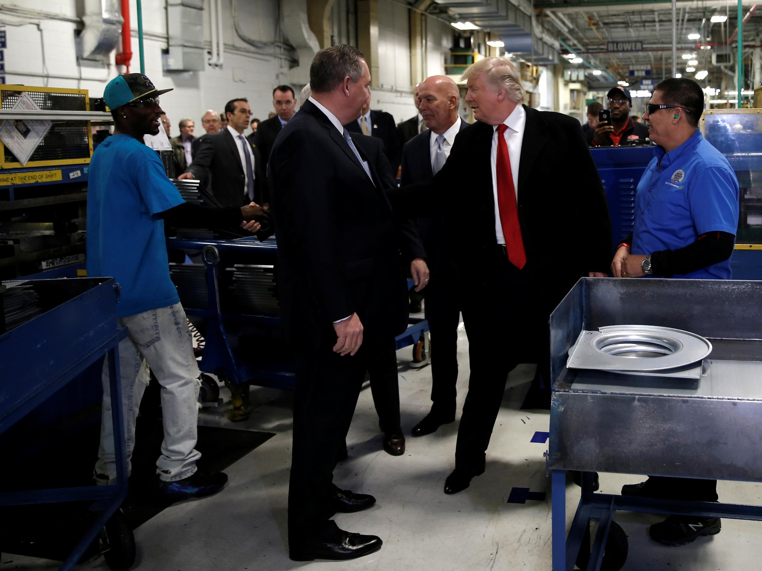 Donald Trump greets workers as he tours a Carrier factory with United Technologies CEO Greg Hayes in Indianapolis, Indiana, on 1 December 2016